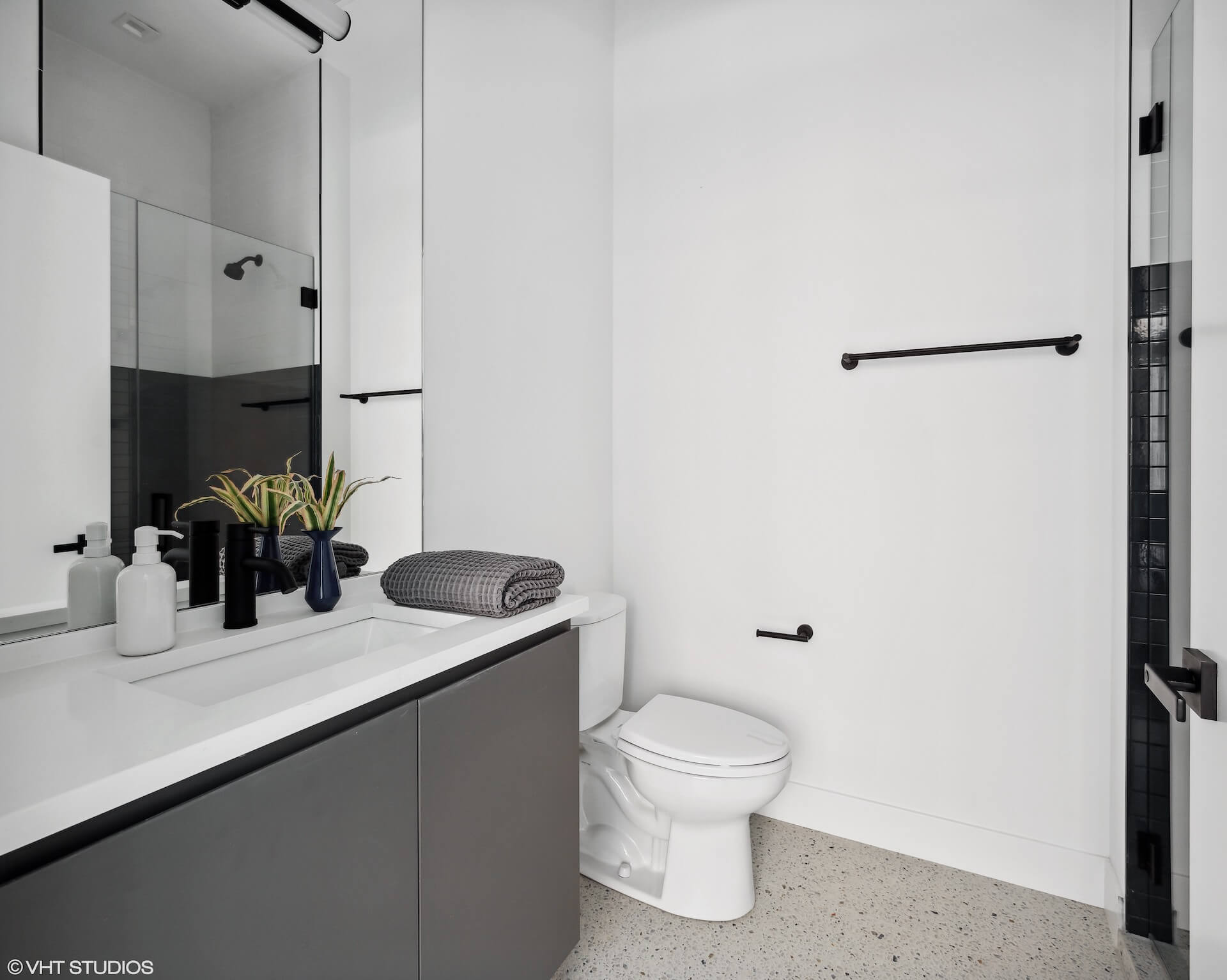 Modern minimalist bathroom with rectangular sink, custom fixtures, and granite style countertops.