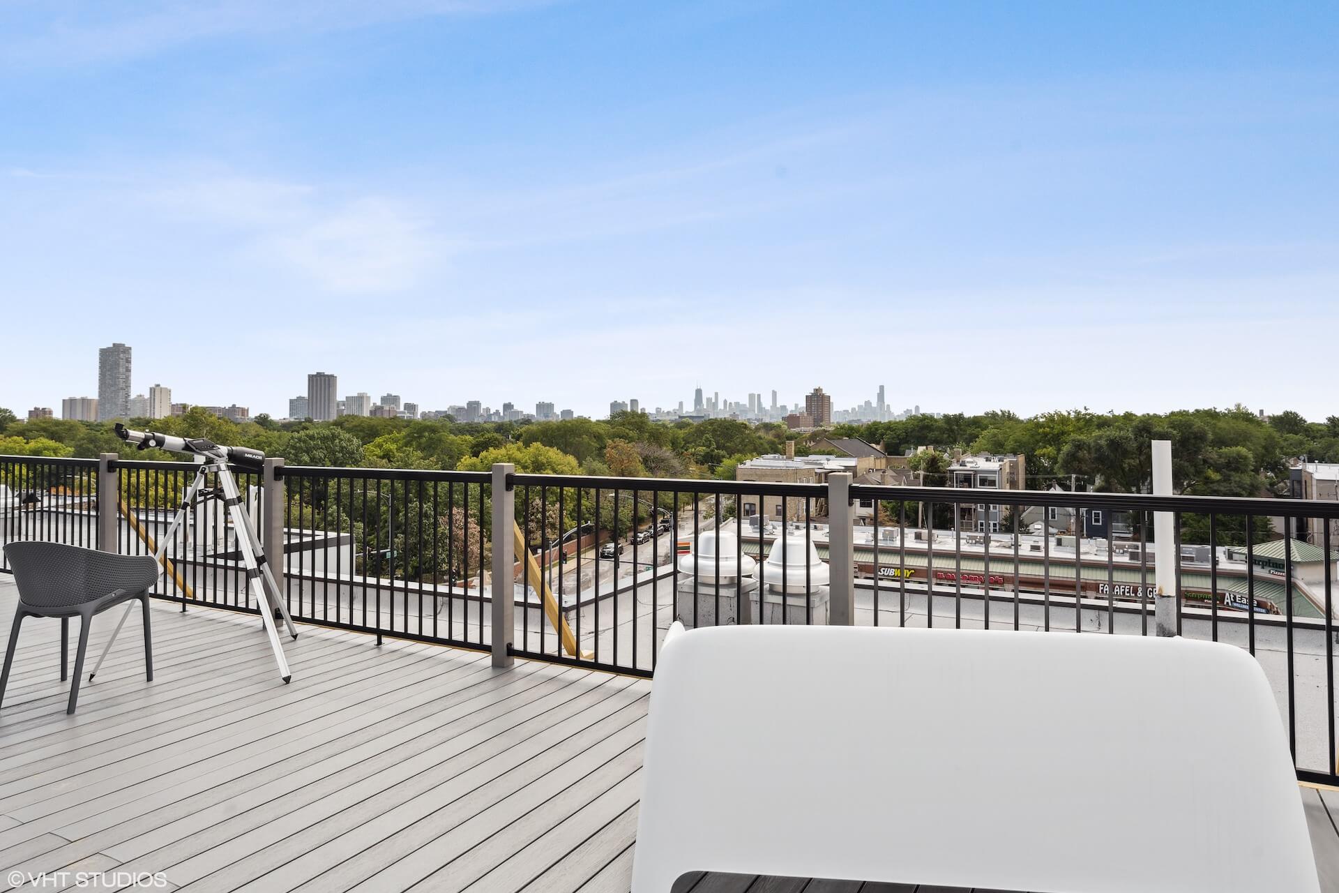 Private rooftop deck with telescope and view of the downtown Chicago skyline.