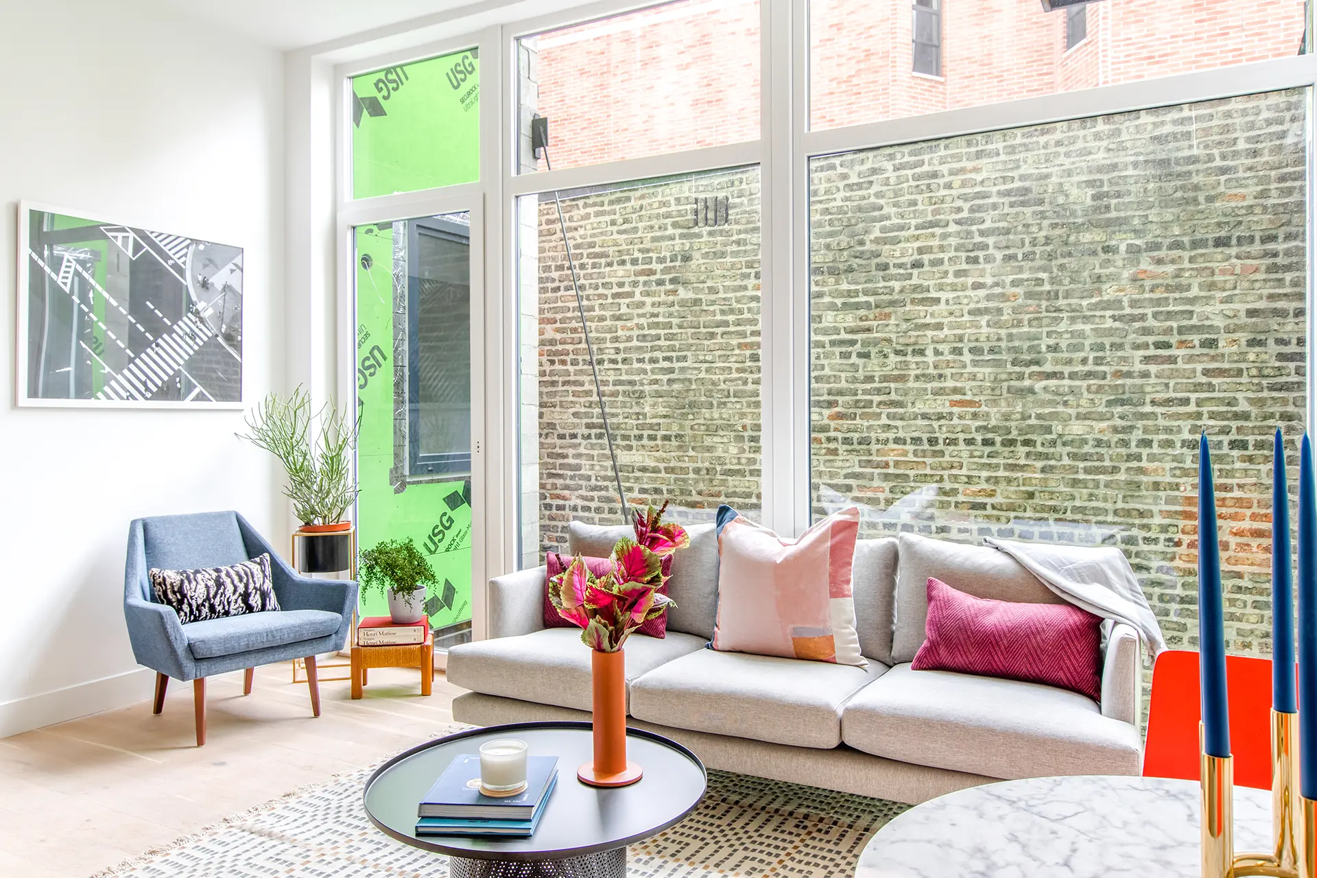 main living space with wall to all, floor to ceiling windows and wood style floors.