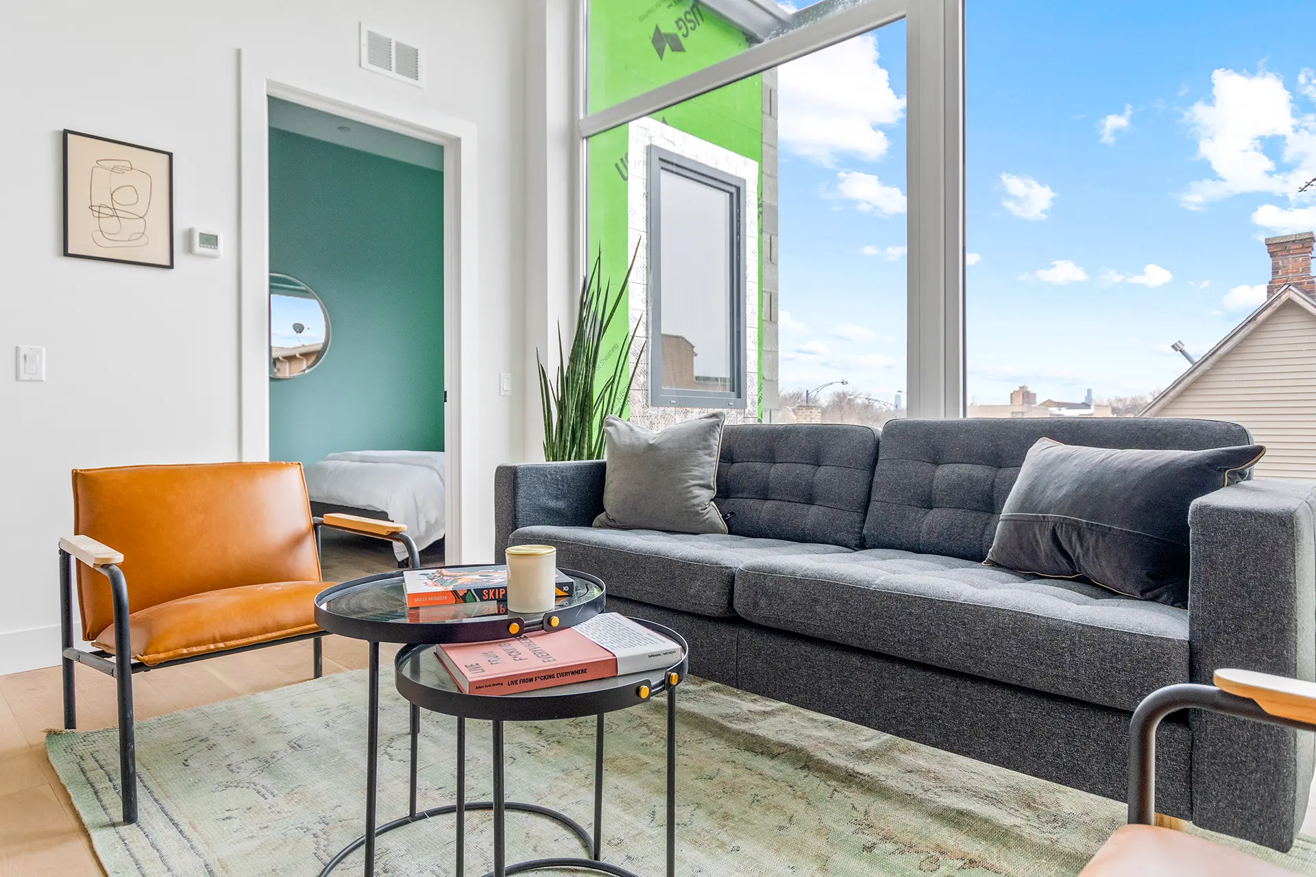 main living space with wall to wall floor to ceiling windows and door open to a bedroom.