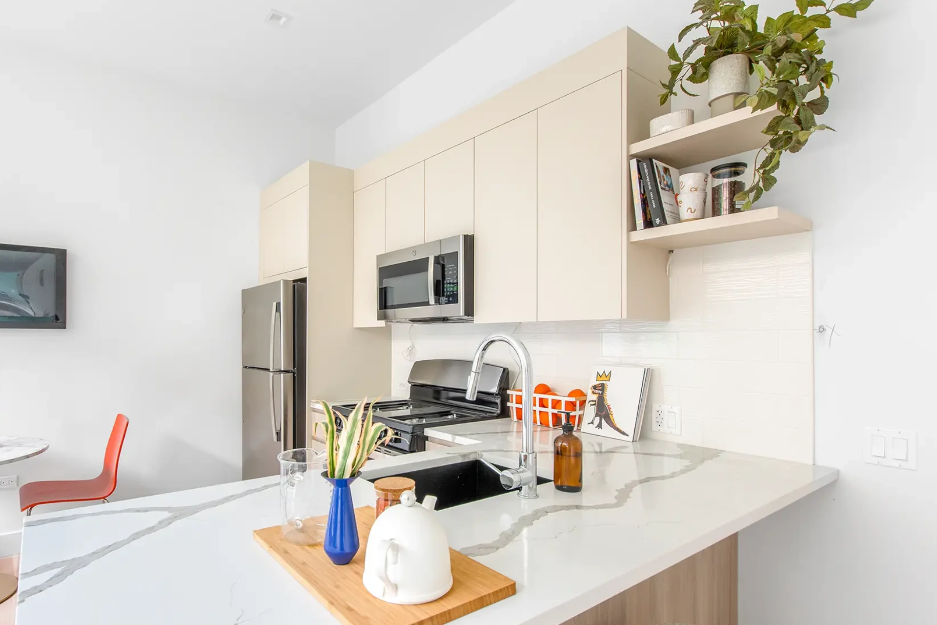 kitchen with modern white cabinets and white granite style countertops with gray veining.